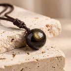 Colgante «Esfera» de obsidiana dorada